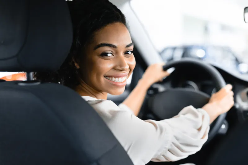 woman in car smiling